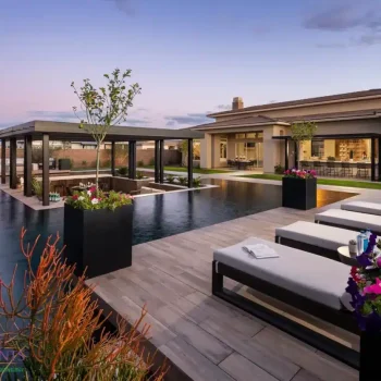 GRAND Backyard design with metal planters and annual flowers.