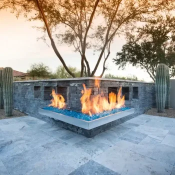 Saguaro Estates (3) Custom backyard design with angled fireplace, cacti and travertine tiles.