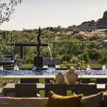 Shadowridge_Backyard_5613LOGO Custom backyard design with double water feature, multiple seating areas and bubblers in black pool.