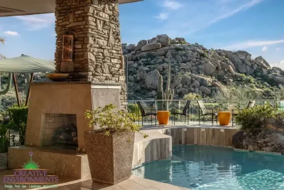 Backyard design with multiple seating areas and fireplace.