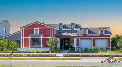 Custom front yard design with organized planting, annuals and farmhouse design.