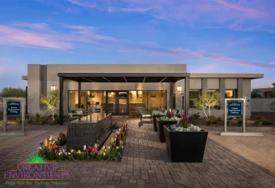 Custom entryway with water feature, large planters and up lighting.