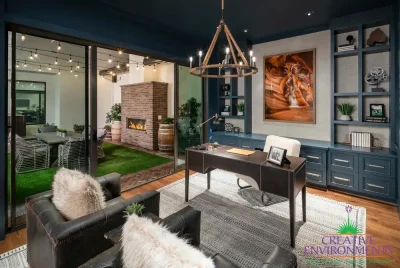 Custom indoor/outdoor design fusion with string lights, brick fireplace and artificial turf.