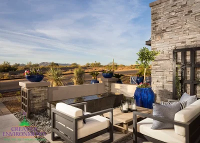 Custom courtyard design with water feature, metal trellis and outdoor seating area.