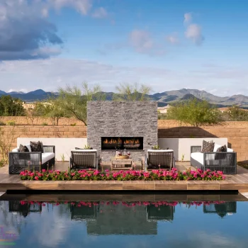 VerdeRiver_Madison_Pool_1344(LOGO) Custom backyard design with fireplace, raised seating area and zero-edge pool.