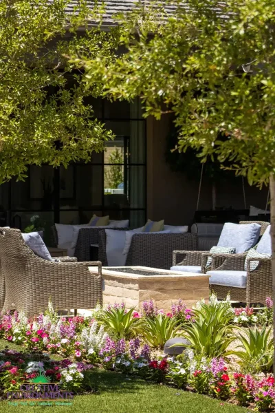Custom backyard design with fire pit, multiple seating areas and annuals.